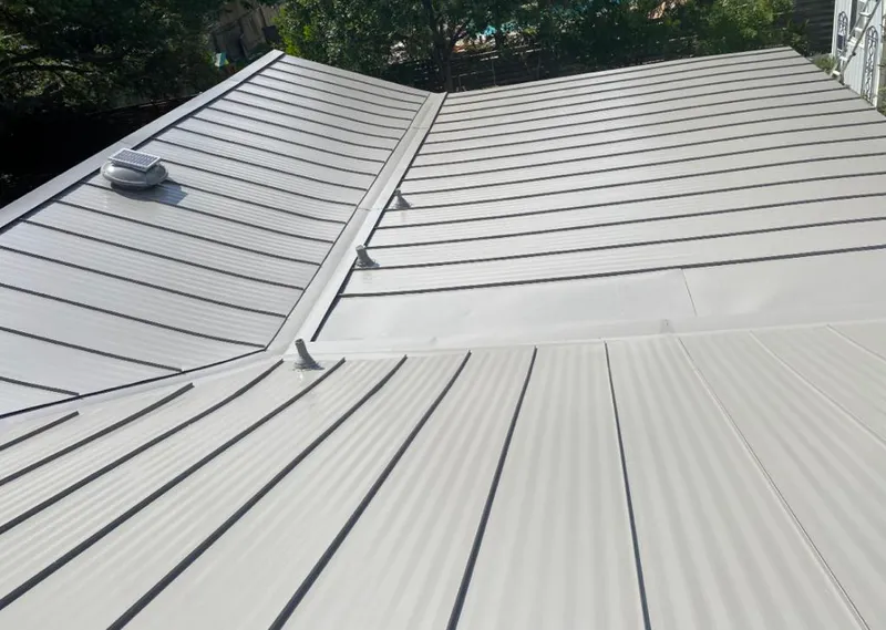 Solar attic fan installed on a metal roof for Roof Ventilation in Center Line